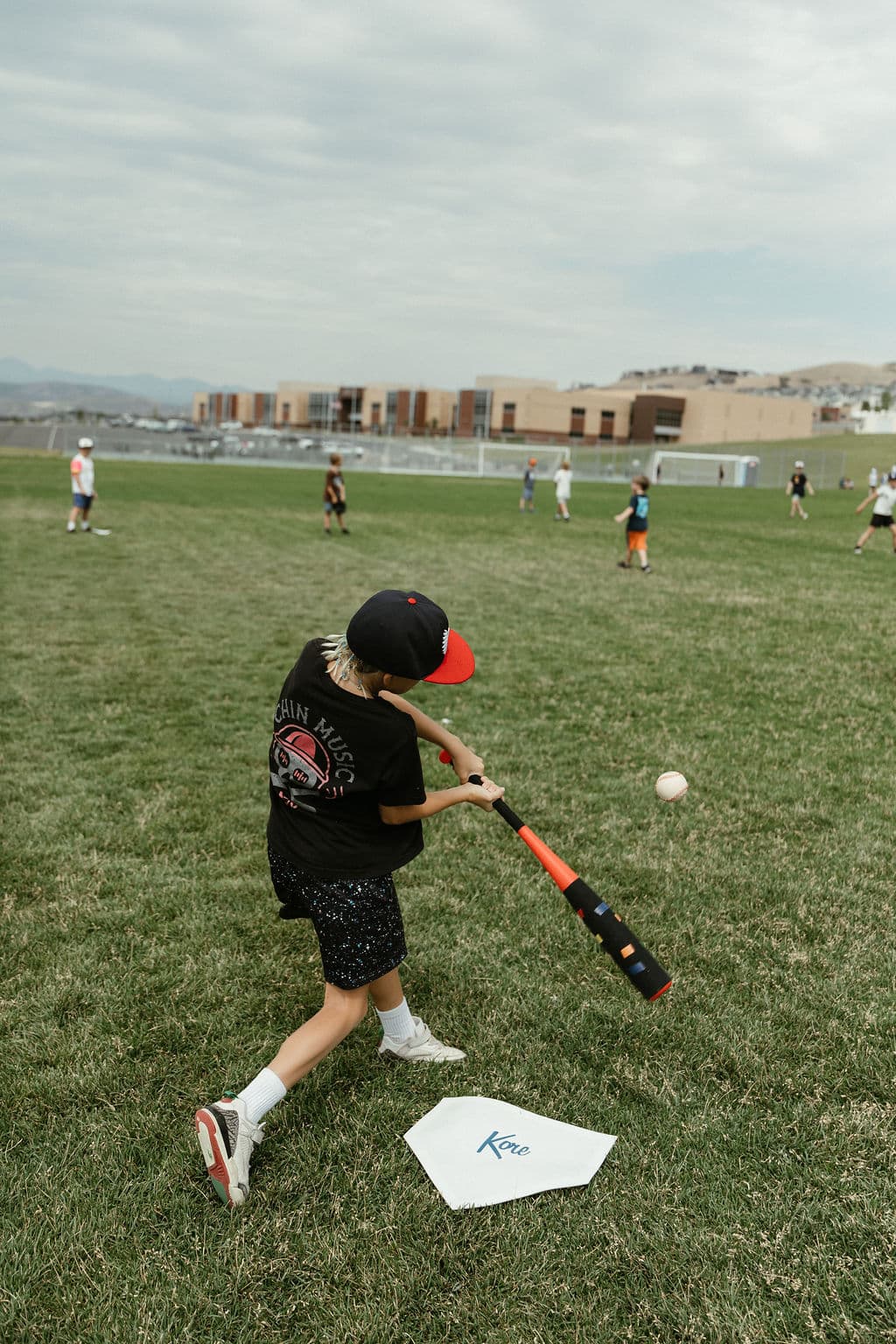 Kid taking a baseball swing